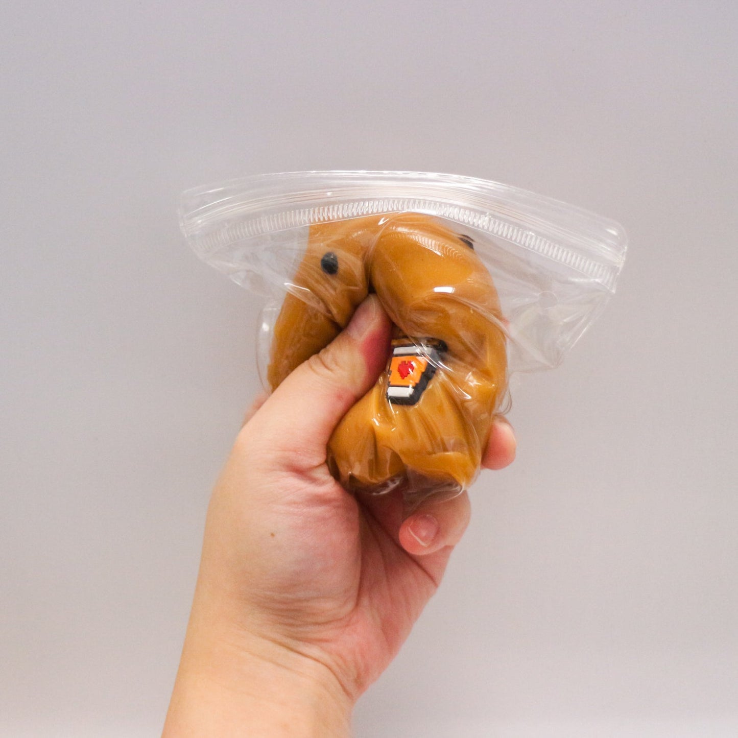 Squeezy Capybara Buddy toy being squeezed by hand