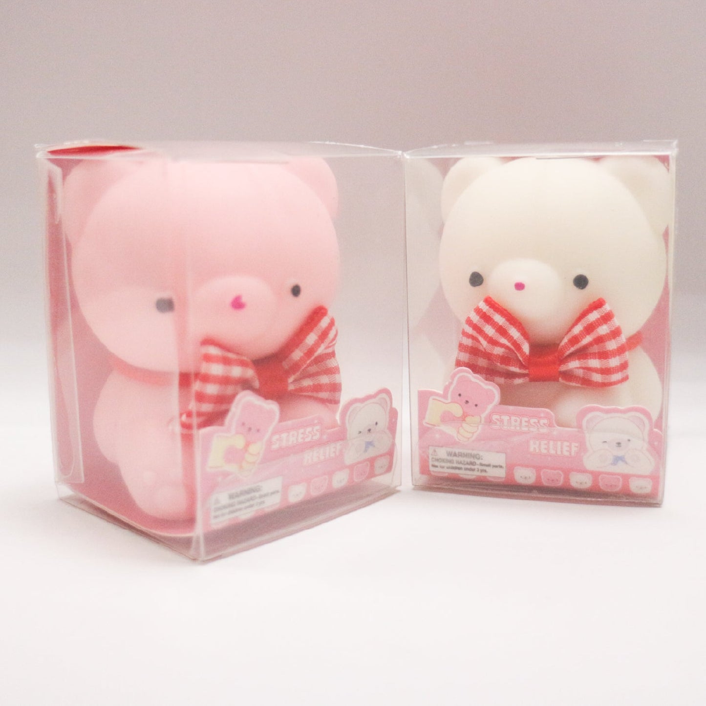 Pink and white BowBear squishy toys in individual boxes