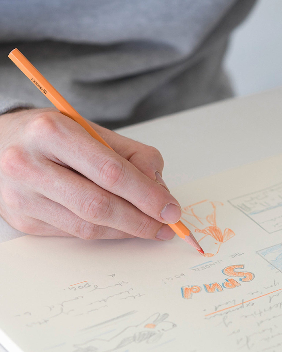 Orange MD Colored Pencil being used for drawing and notes